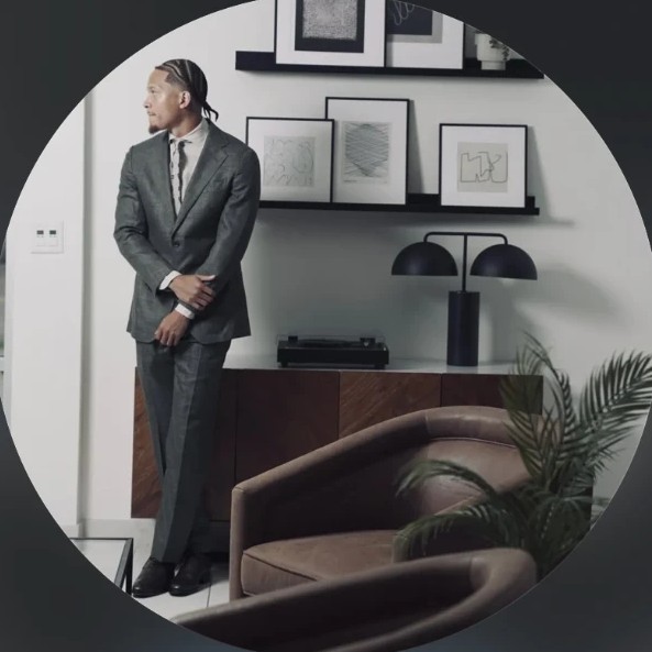 RJ, founder of Living Heat Consulting, in a grey suit